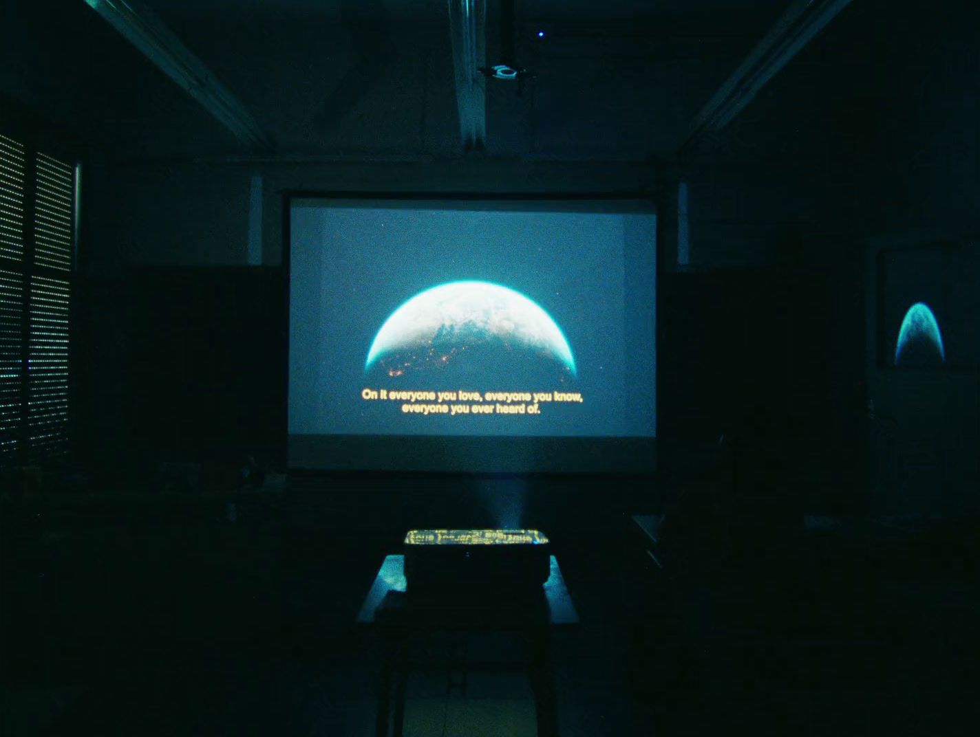 a projection screen in a dark room