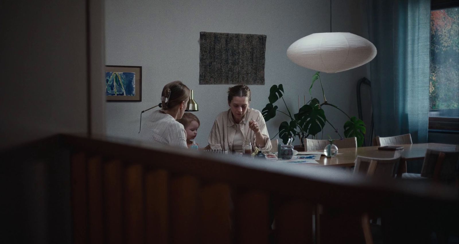 a man and woman sitting at a table with a child