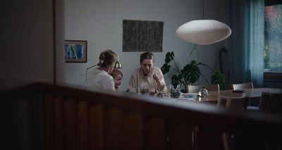 a man and woman sitting at a table with a child
