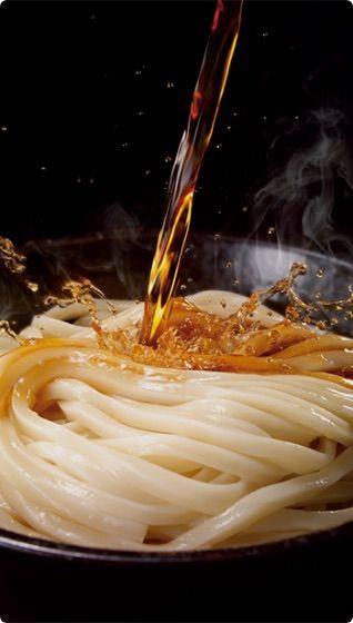 a bowl of noodles being stirred with a sauce