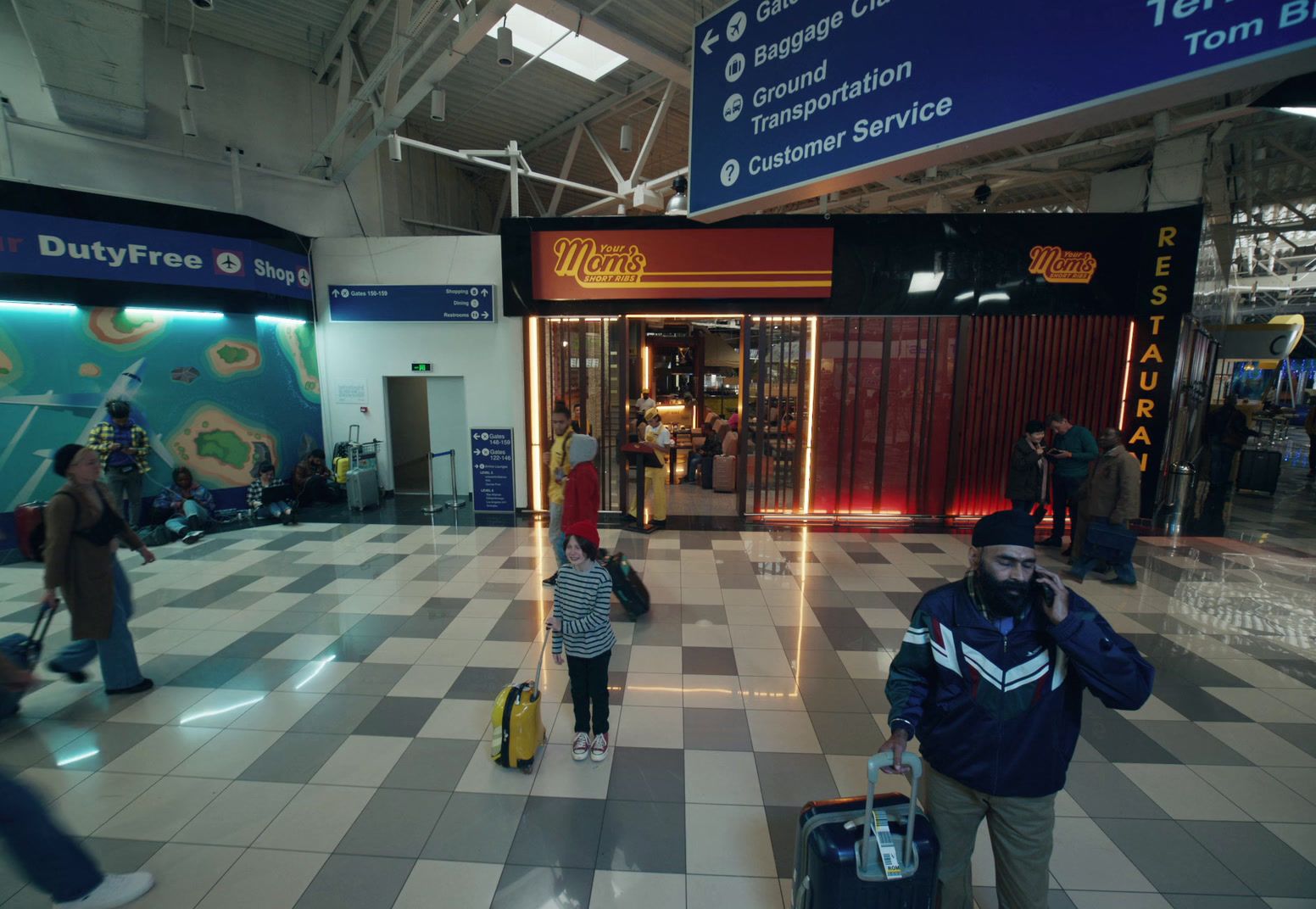 a man is walking through an airport with his luggage