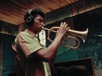 a man in headphones playing a trumpet