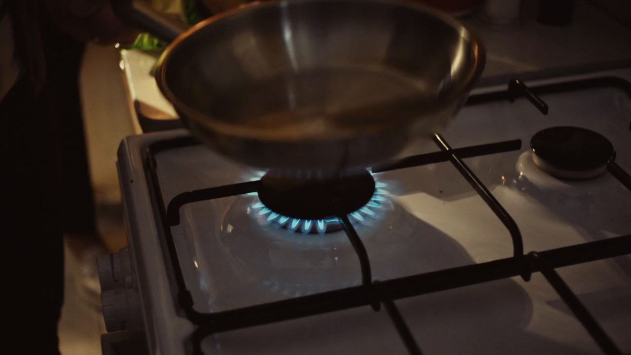 a metal bowl sitting on top of a gas stove