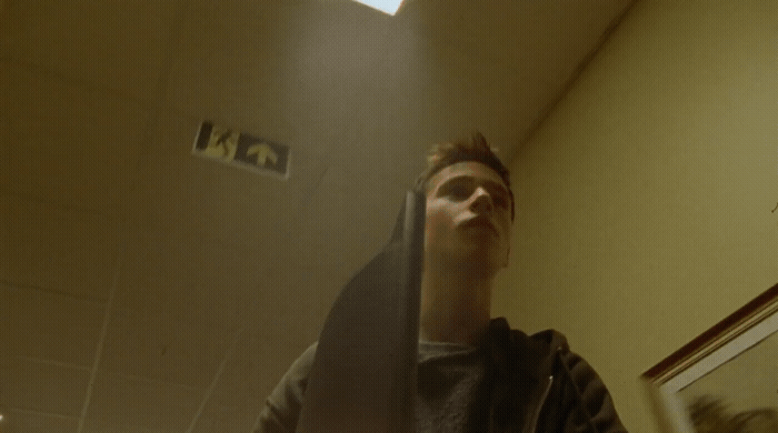 a man standing in front of a mirror in a bathroom