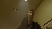 a man standing in front of a mirror in a bathroom