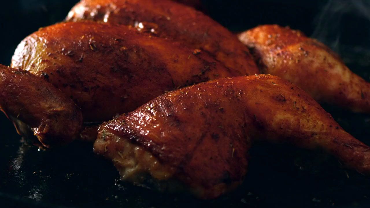 a close up of some chicken on a grill