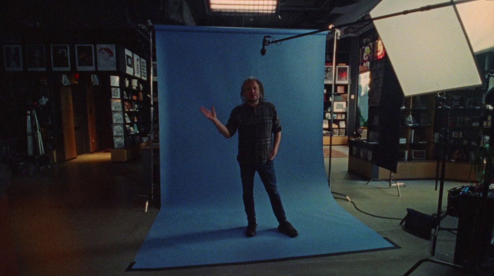 a man standing in front of a blue screen