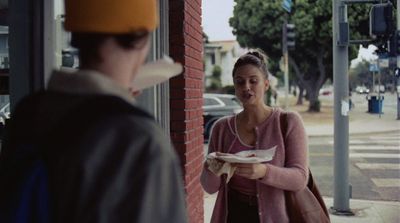 a woman holding a plate of food standing next to a man