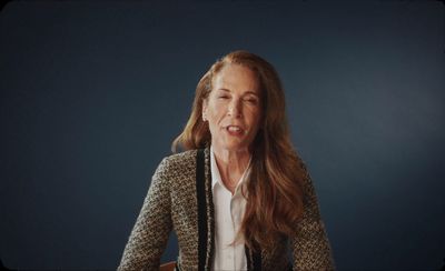 a woman with long hair wearing a jacket