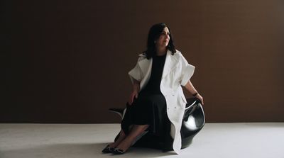 a woman sitting on a chair in a room