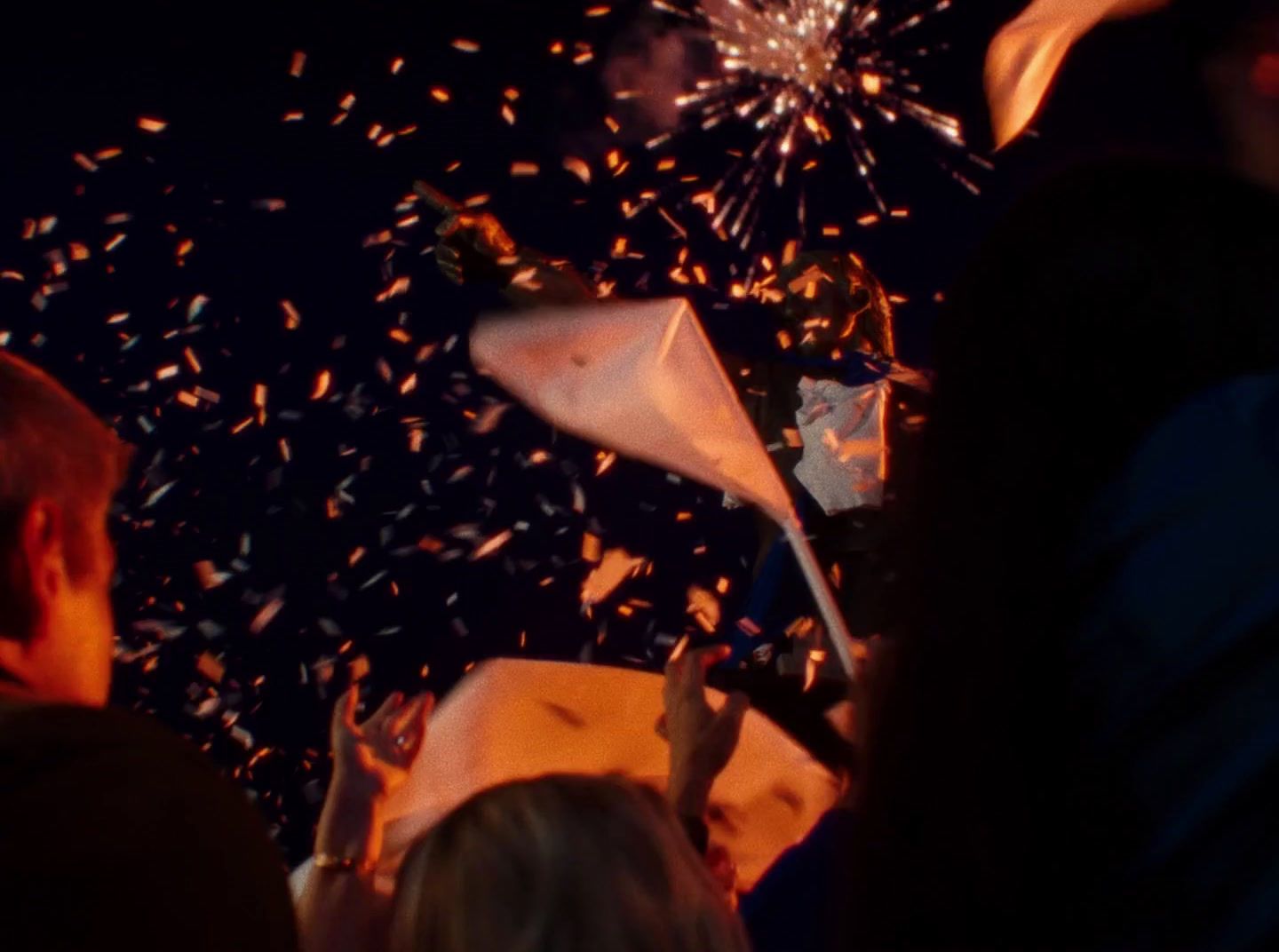 a group of people standing around a firework display