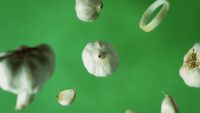 a bunch of garlic on a green background