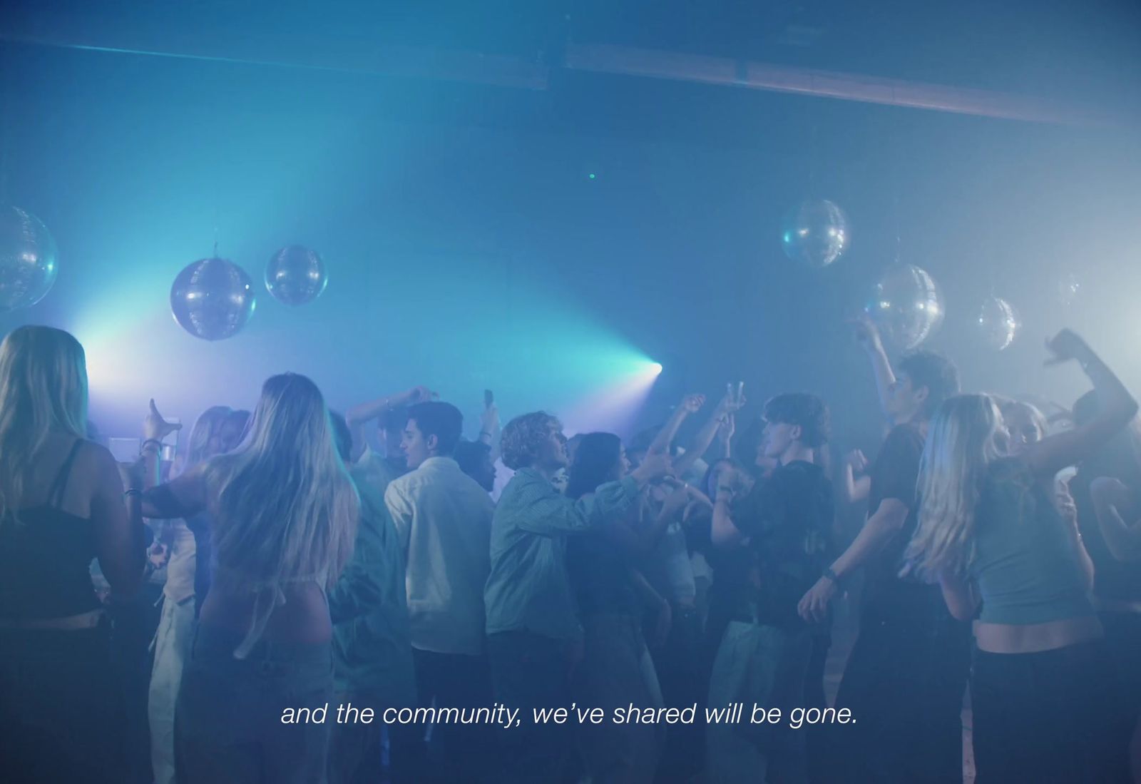 a group of people standing around each other at a party