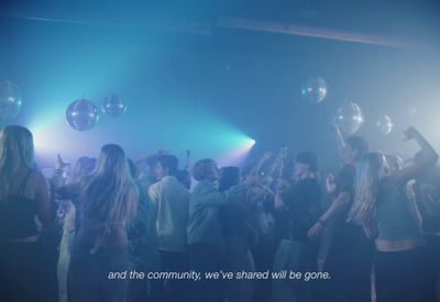 a group of people standing around each other at a party