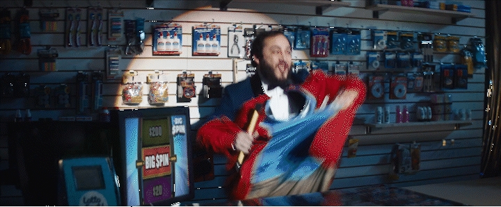 a man in a room with a lot of items on the wall