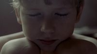 a close up of a child with closed eyes
