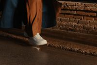 a person walking up some steps with a coat on