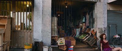 a woman sitting in a doorway of a building