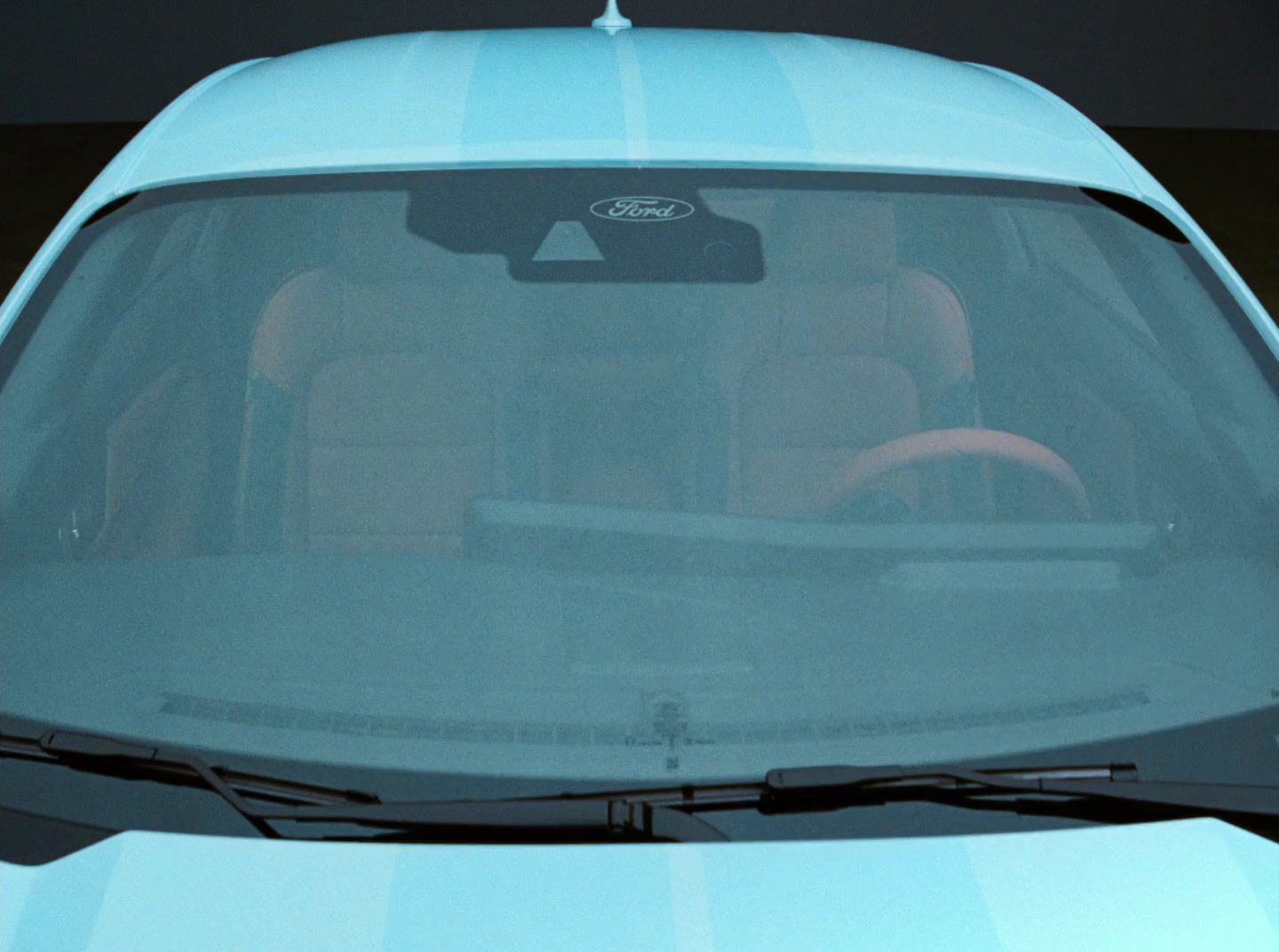 a close up of a blue car with a steering wheel