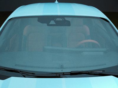 a close up of a blue car with a steering wheel