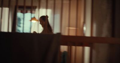 a woman standing in a room next to a window