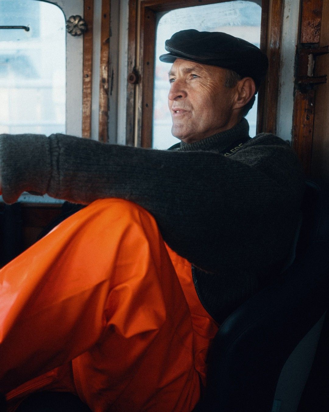 a man sitting on a train looking out the window