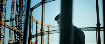 a man standing in front of a metal structure