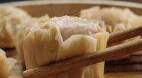 dumplings with chopsticks in a wooden bowl