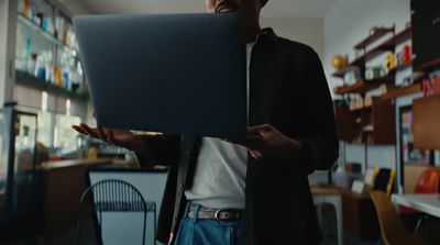 a man holding a laptop in his hands