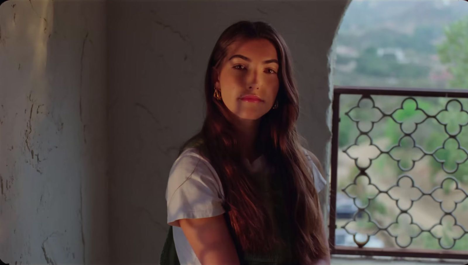 a woman standing in front of a window