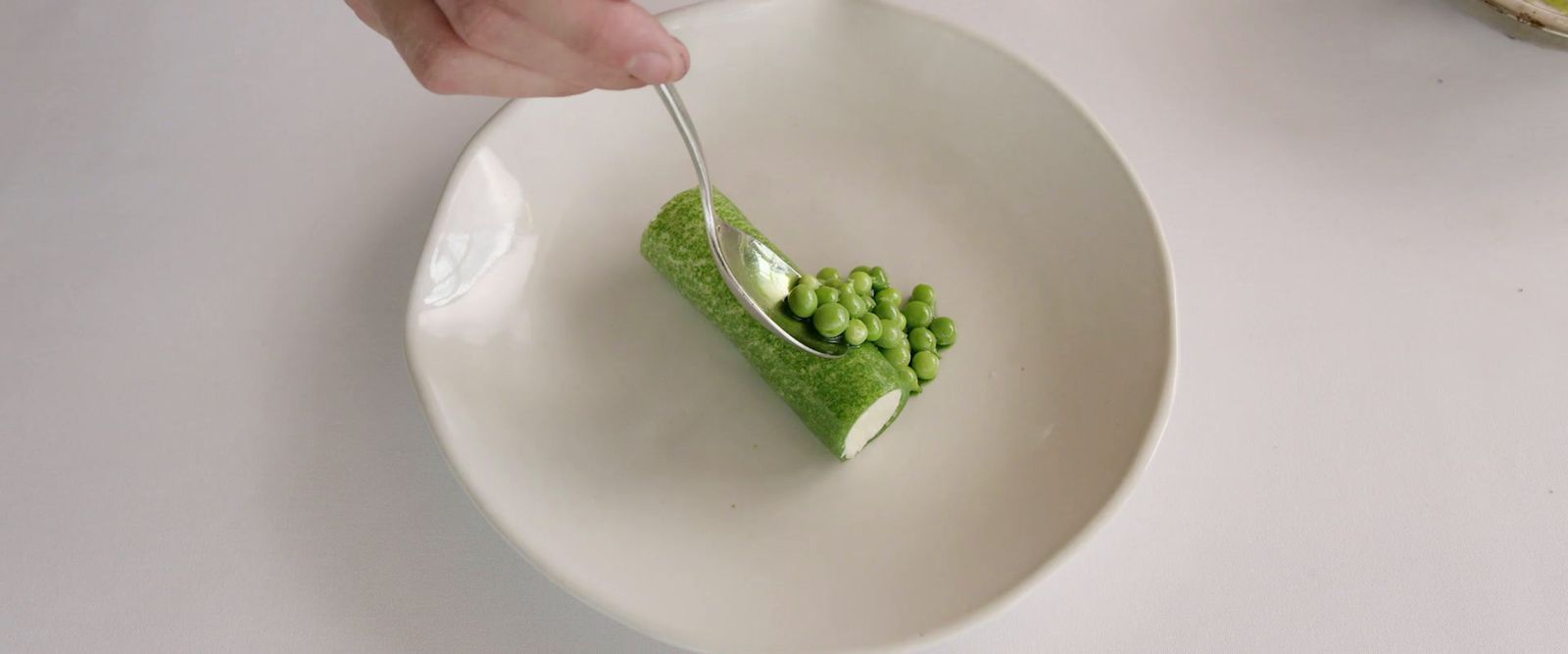 a white plate topped with a piece of green cake