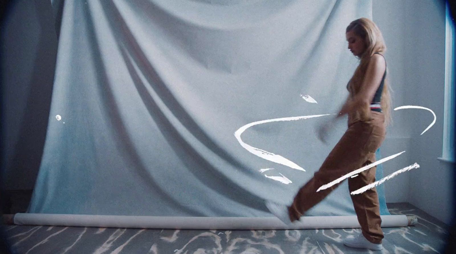 a woman standing in front of a white curtain