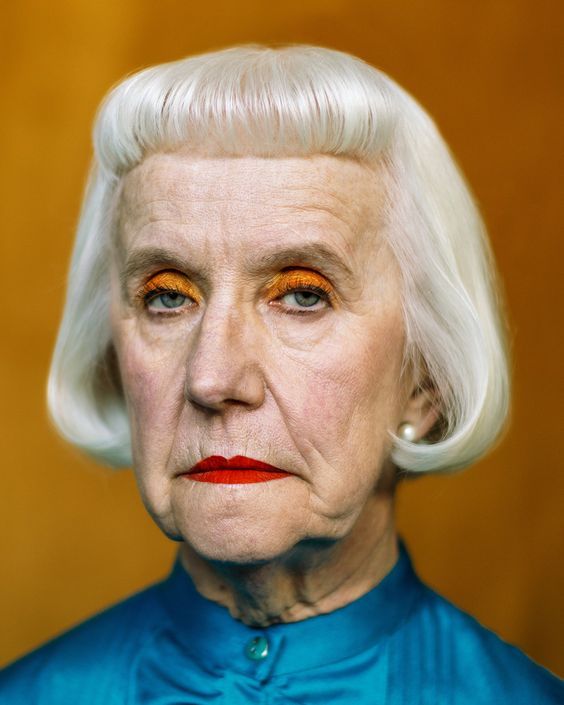 an old woman with white hair and orange eyes