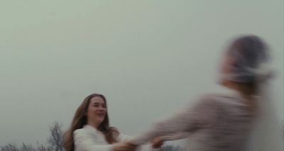 a blurry photo of a woman and a man holding hands