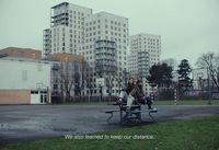 a couple of people sitting on top of a bench