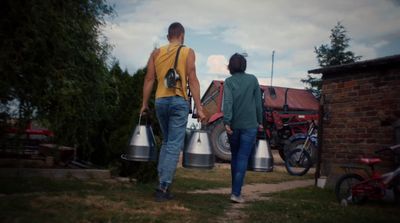 a couple of people walking down a sidewalk