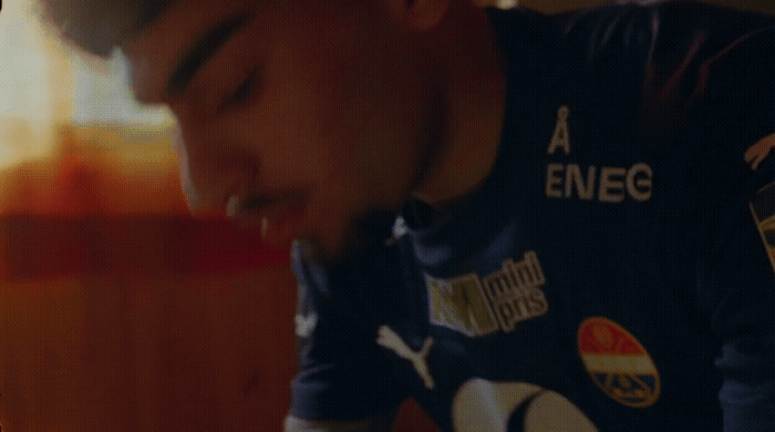 a man is blowing out a candle on a cake