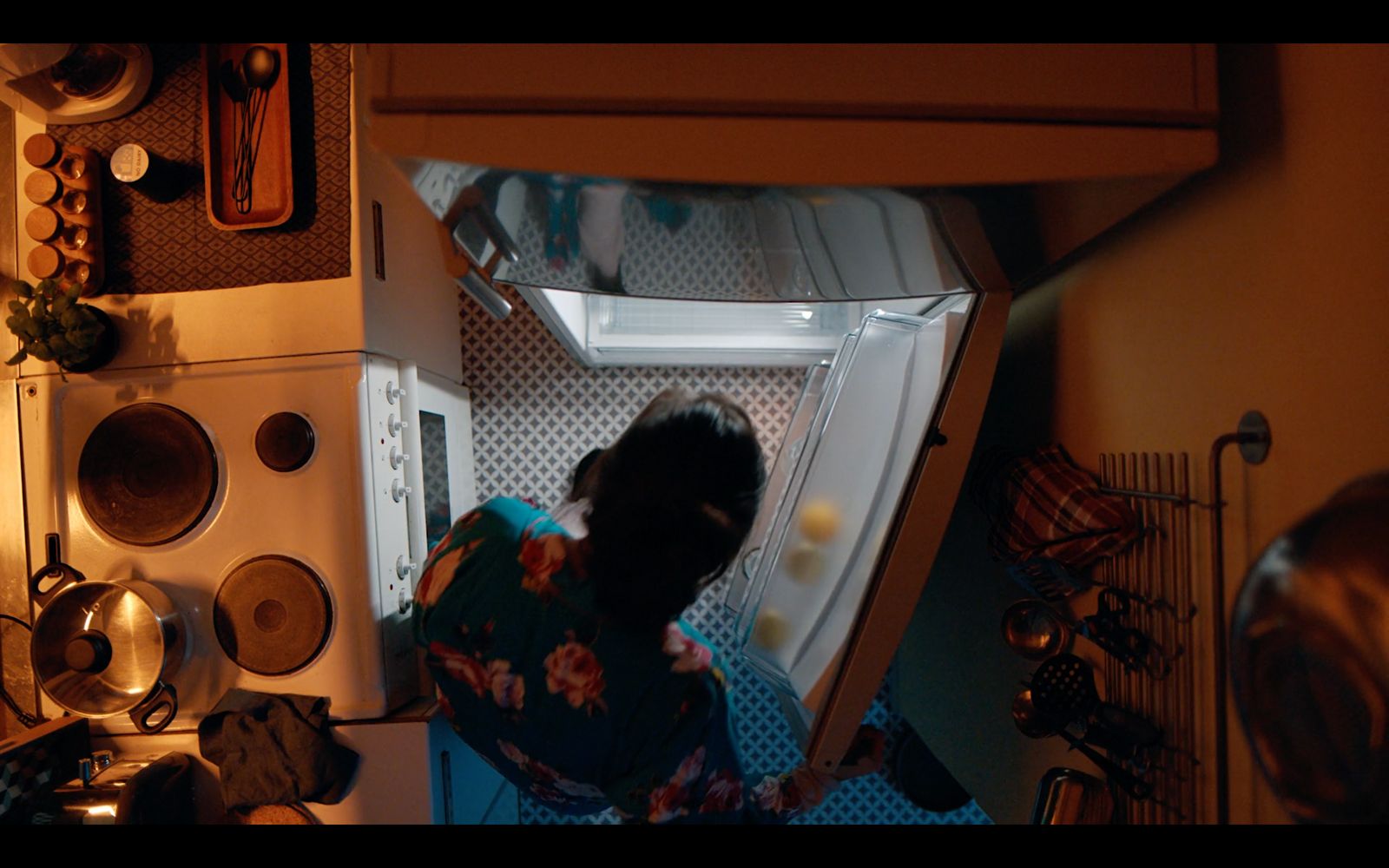 a person standing inside of a refrigerator in a kitchen