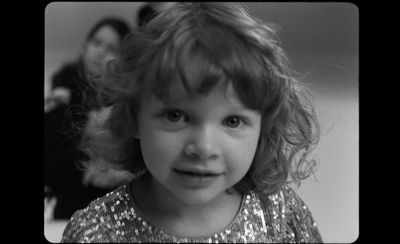 a black and white photo of a little girl