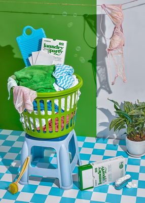 a laundry basket sitting on top of a blue and white checkered table