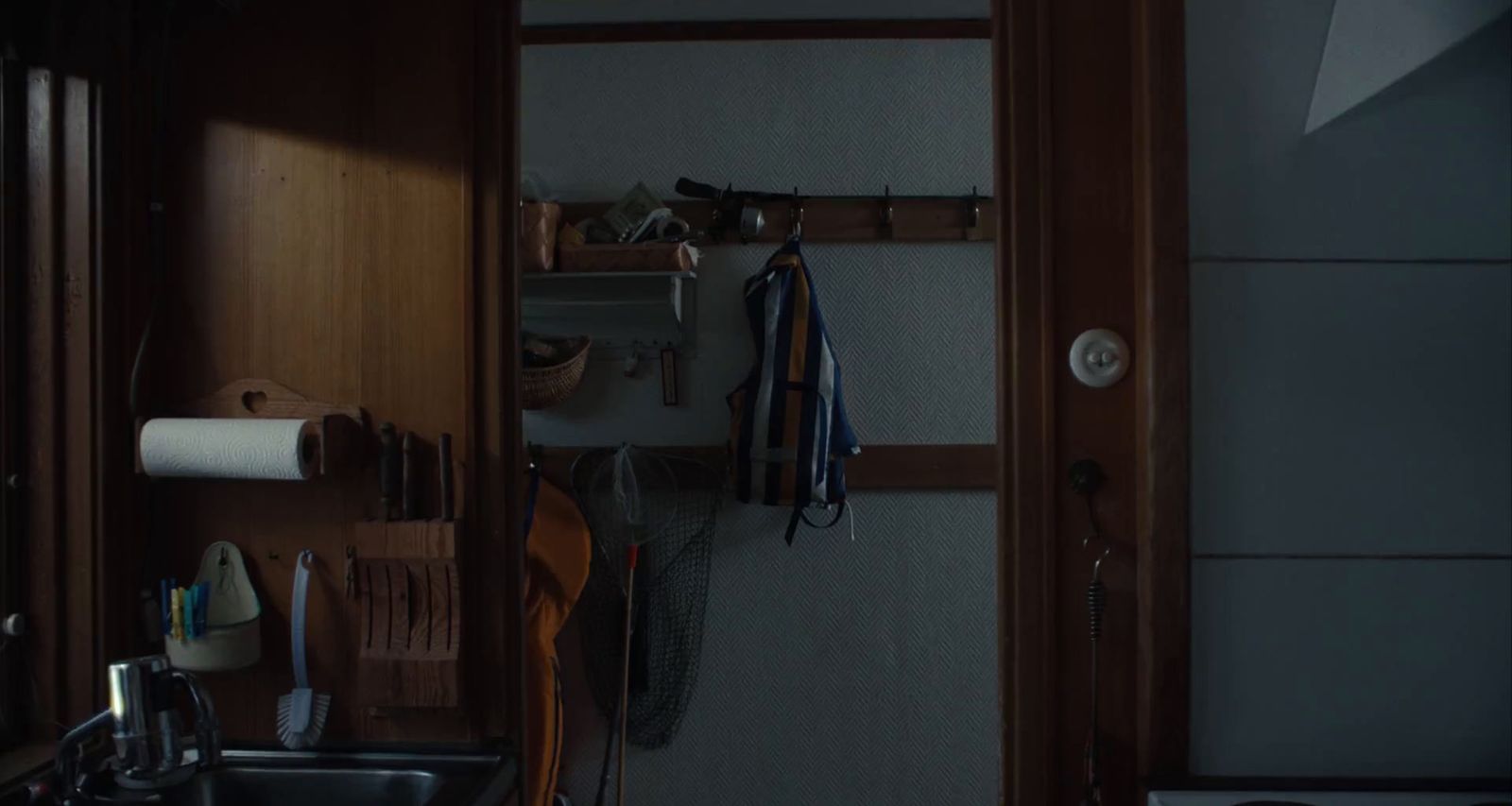a kitchen with a sink and a wooden door