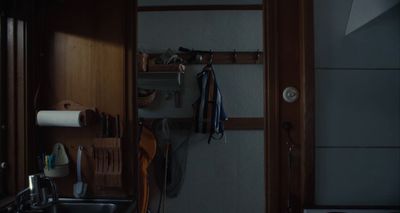 a kitchen with a sink and a wooden door