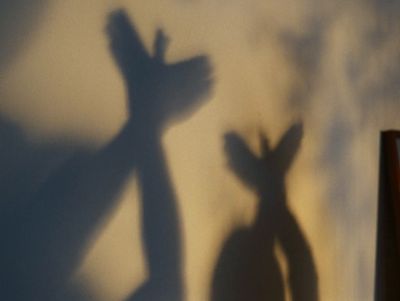 a shadow of two people standing next to each other