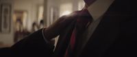 a man in a suit and tie standing in a room