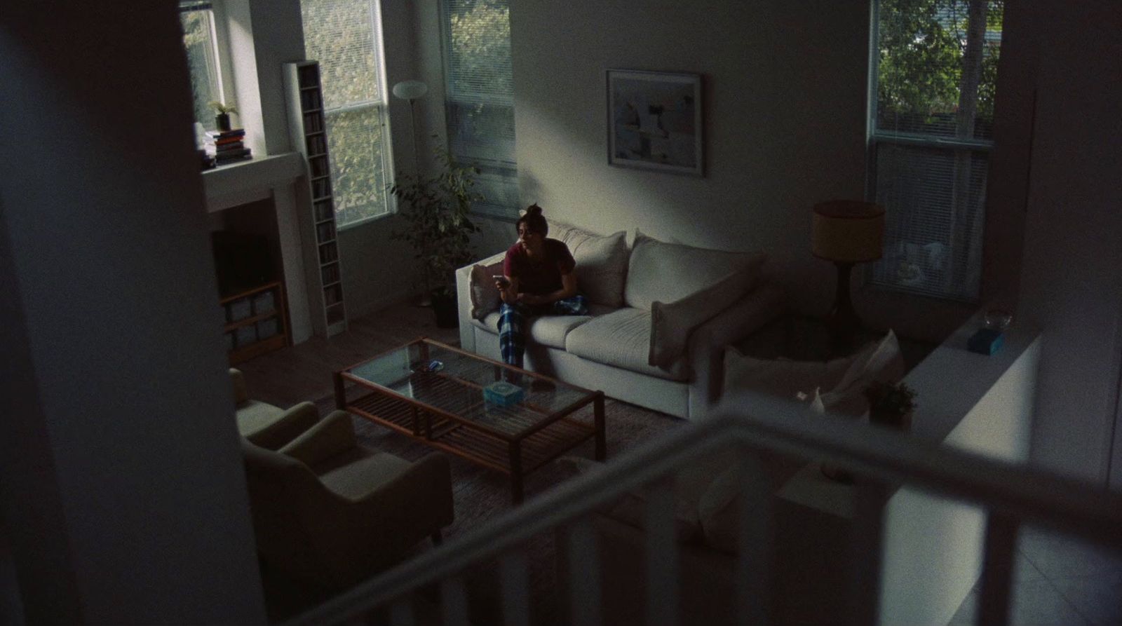a person sitting on a couch in a living room
