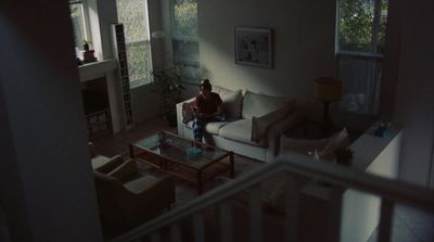 a person sitting on a couch in a living room