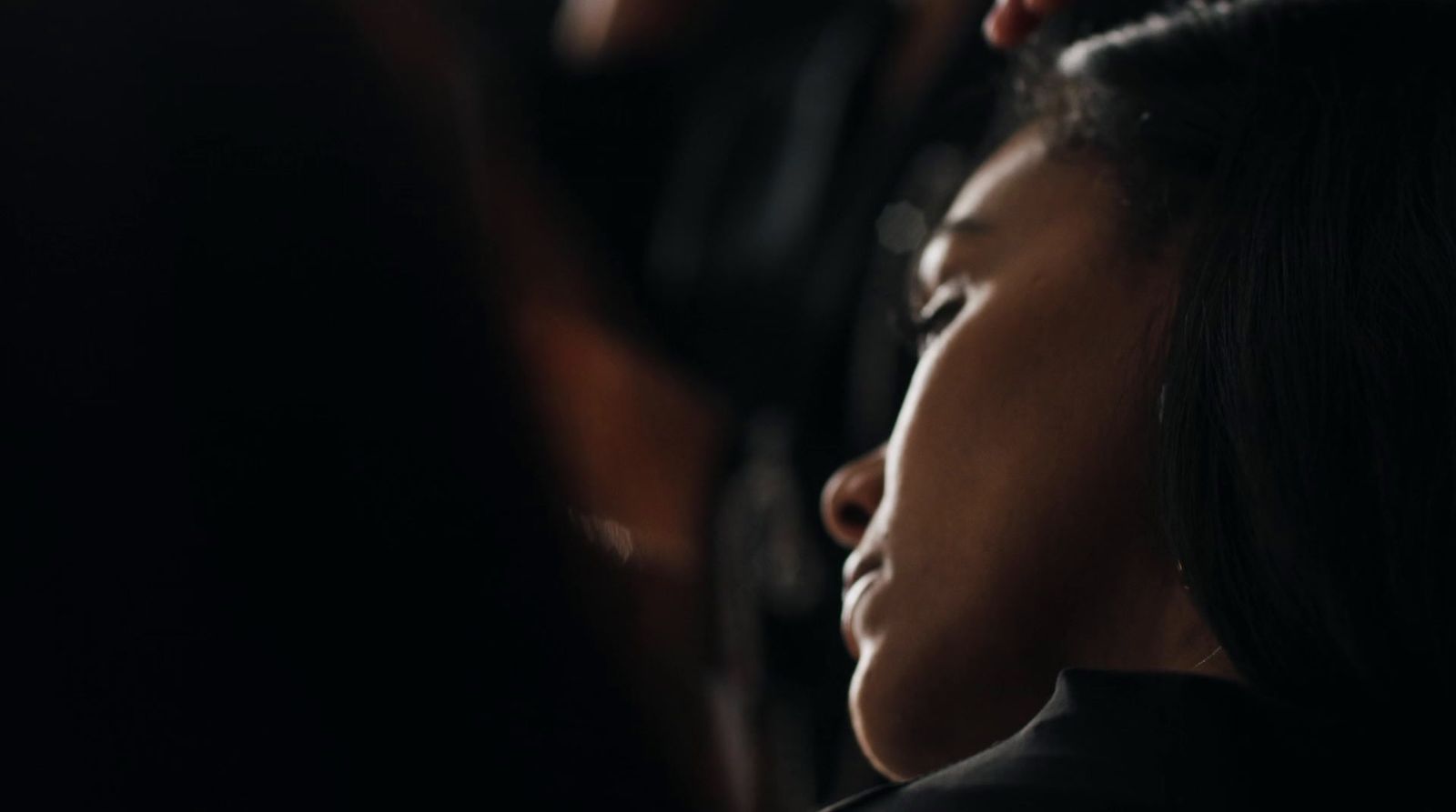 a close up of a woman with her eyes closed