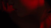 a blurry image of a woman's face in red light