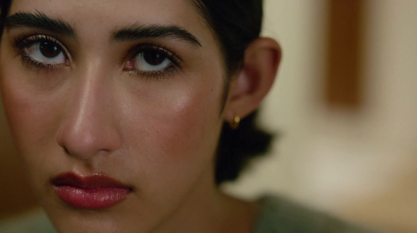 a close up of a woman's face with dark hair