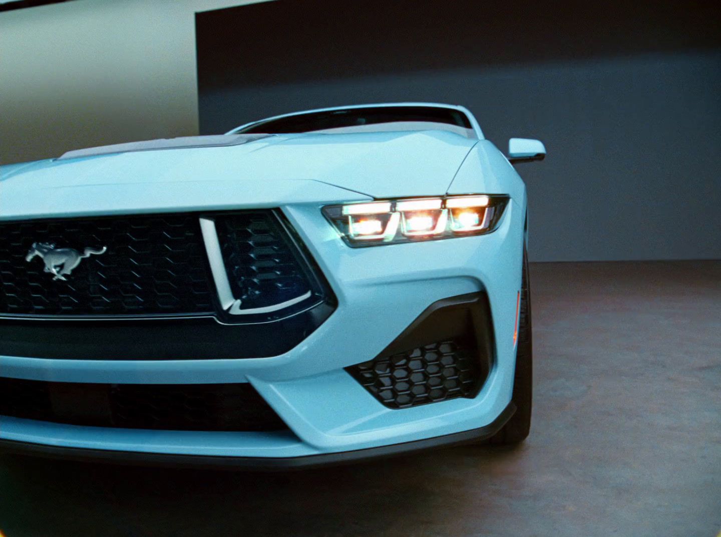 the front end of a blue sports car